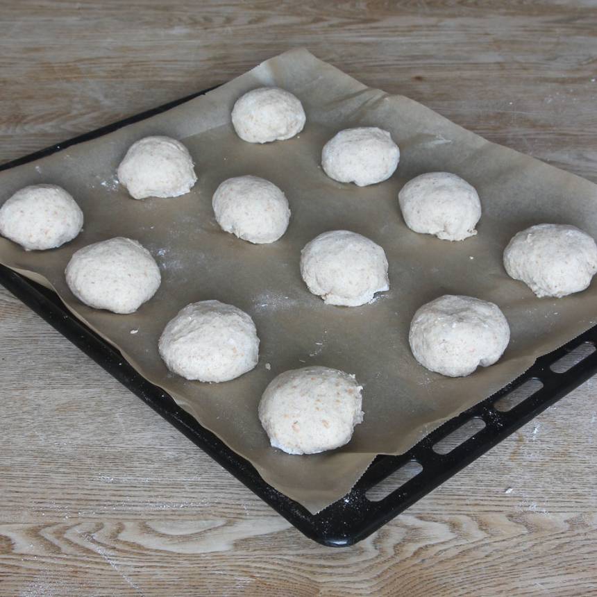 3. Rulla bollar av degen och lägg dem på en plåt med bakplåtspapper. Låt dem jäsa under bakduk i ca 30 min. Sätt ugnen på 250 grader.