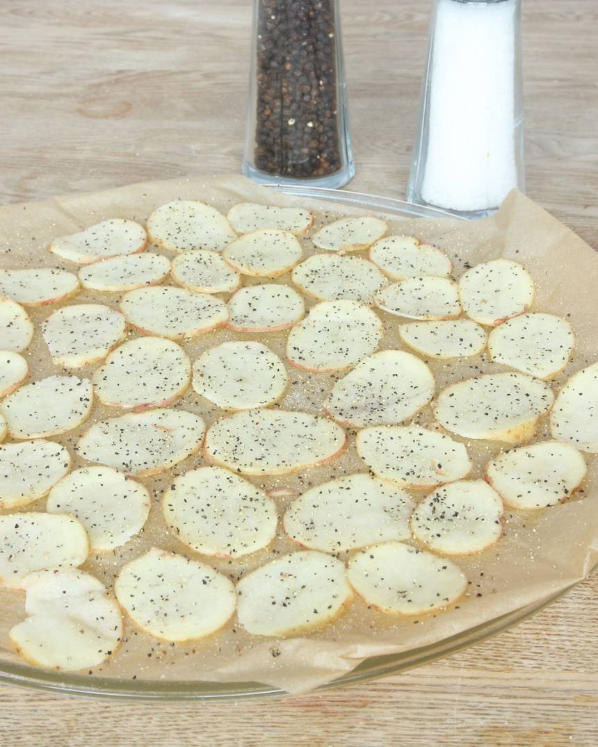 3. Lägg ut potatisarna på bakplåtspappret (de får inte överlappa varandra). Strö över salt och grovmalen peppar.