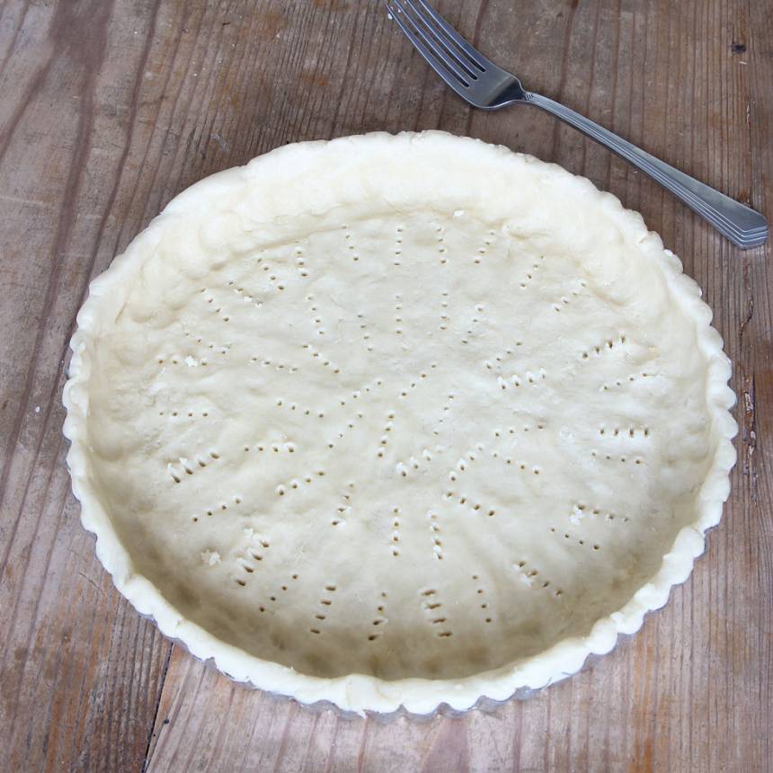 2. Tryck ut degen i en pajform, 24–25 cm i diameter (även på kanterna). Nagga degen i botten med en gaffel och ställ den i kylen i ca 30 min.