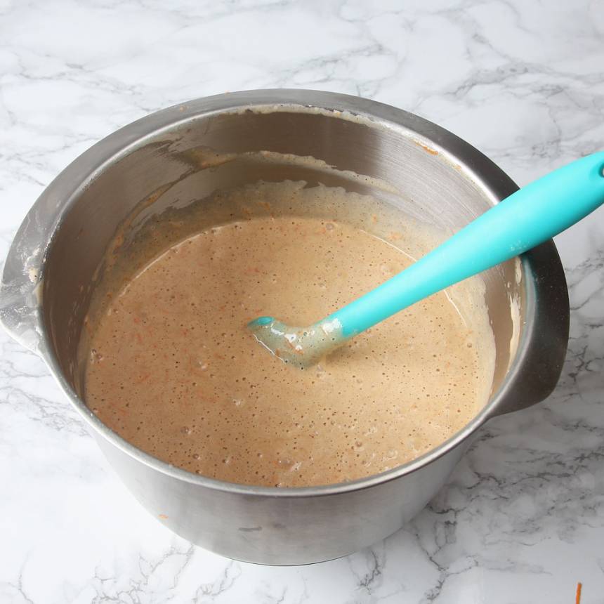 2. Vispa ägg och socker vitt och pösigt i en bunke. Tillsätt olja och morötter. Blanda ihop bakpulver, vaniljsocker, kanel och vetemjöl. Rör ner det i äggsmeten och blanda till en slät smet.