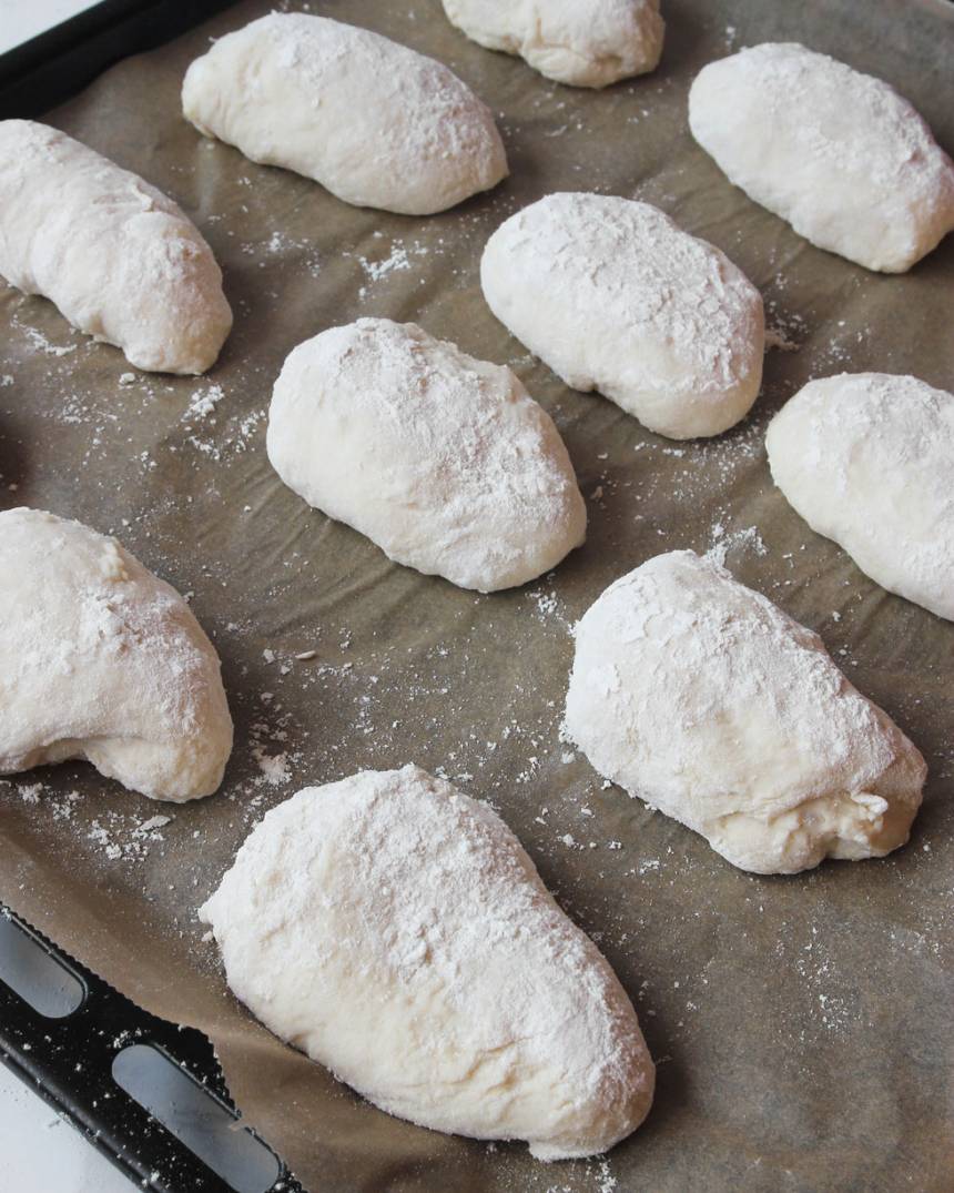 3. Lägg frallorna på en plåt med bakplåtspapper. Låt dem jäsa under bakduk i ca 20 min. Sätt ugnen på 250 grader.